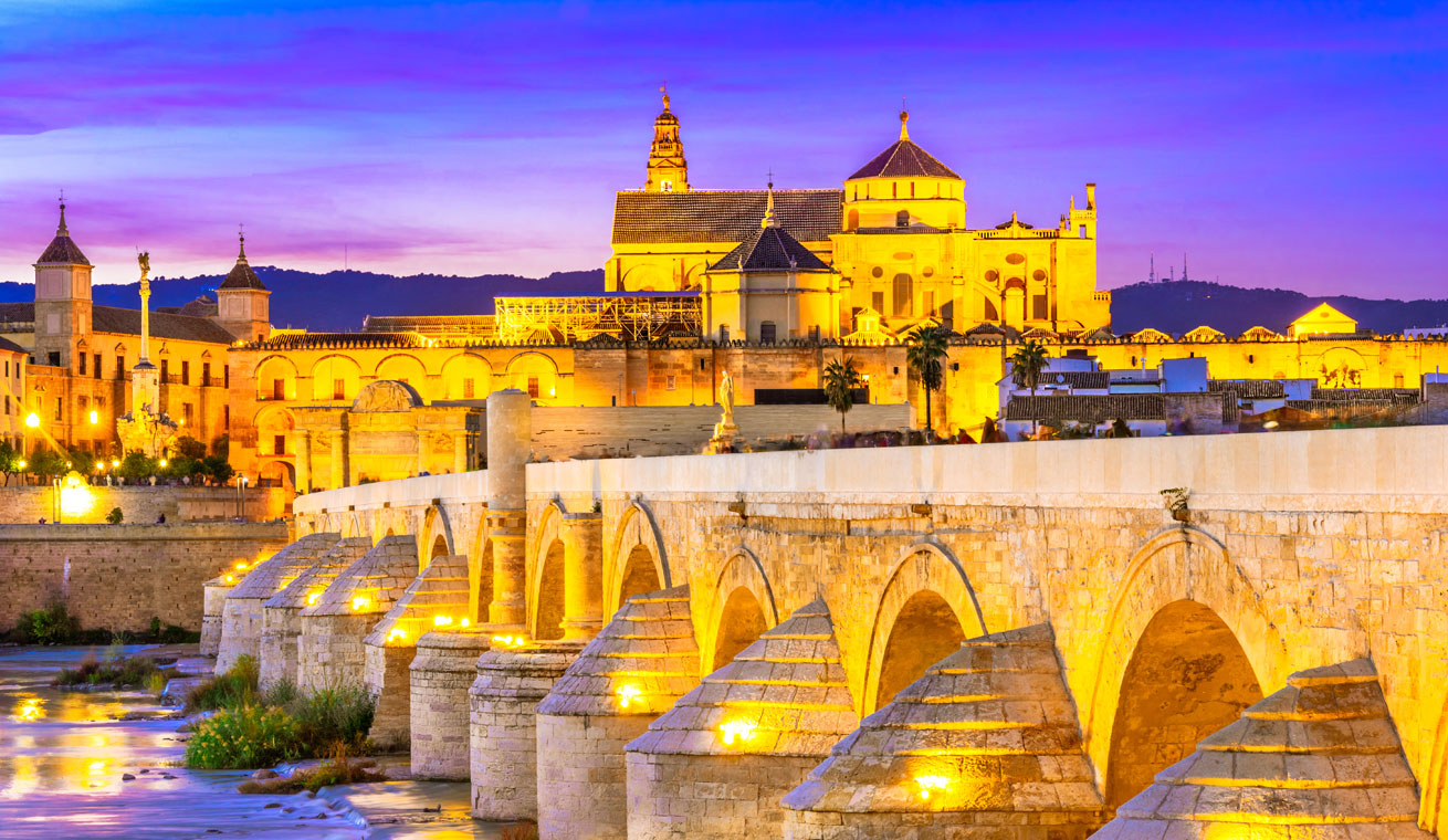 A courtyard in Andalusia, Spain with ornate tile work and flowers